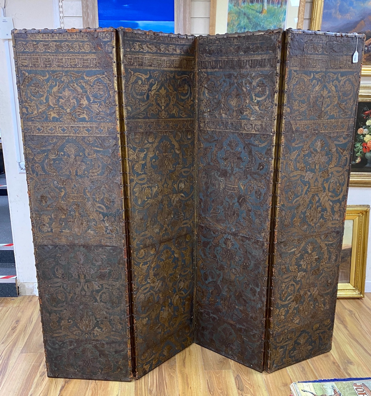 A 19th century French studded leather four fold screen, each panel width 49cm, height 182cm